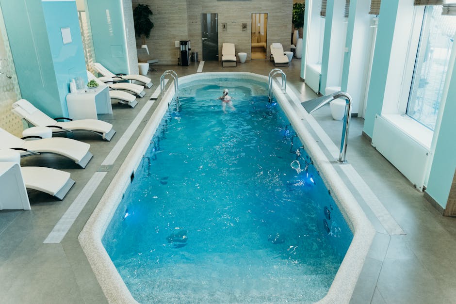 Bright indoor spa pool with lounge chairs