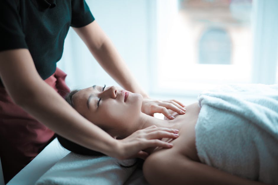 A serene spa massage session with a woman relaxing on a table