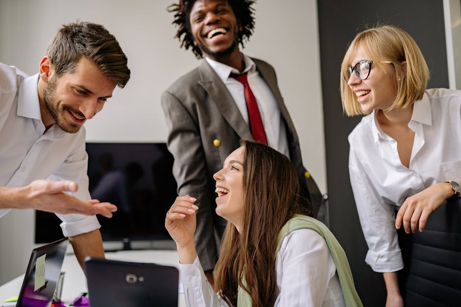 A diverse group of professionals enjoying a light-hearted moment in the office